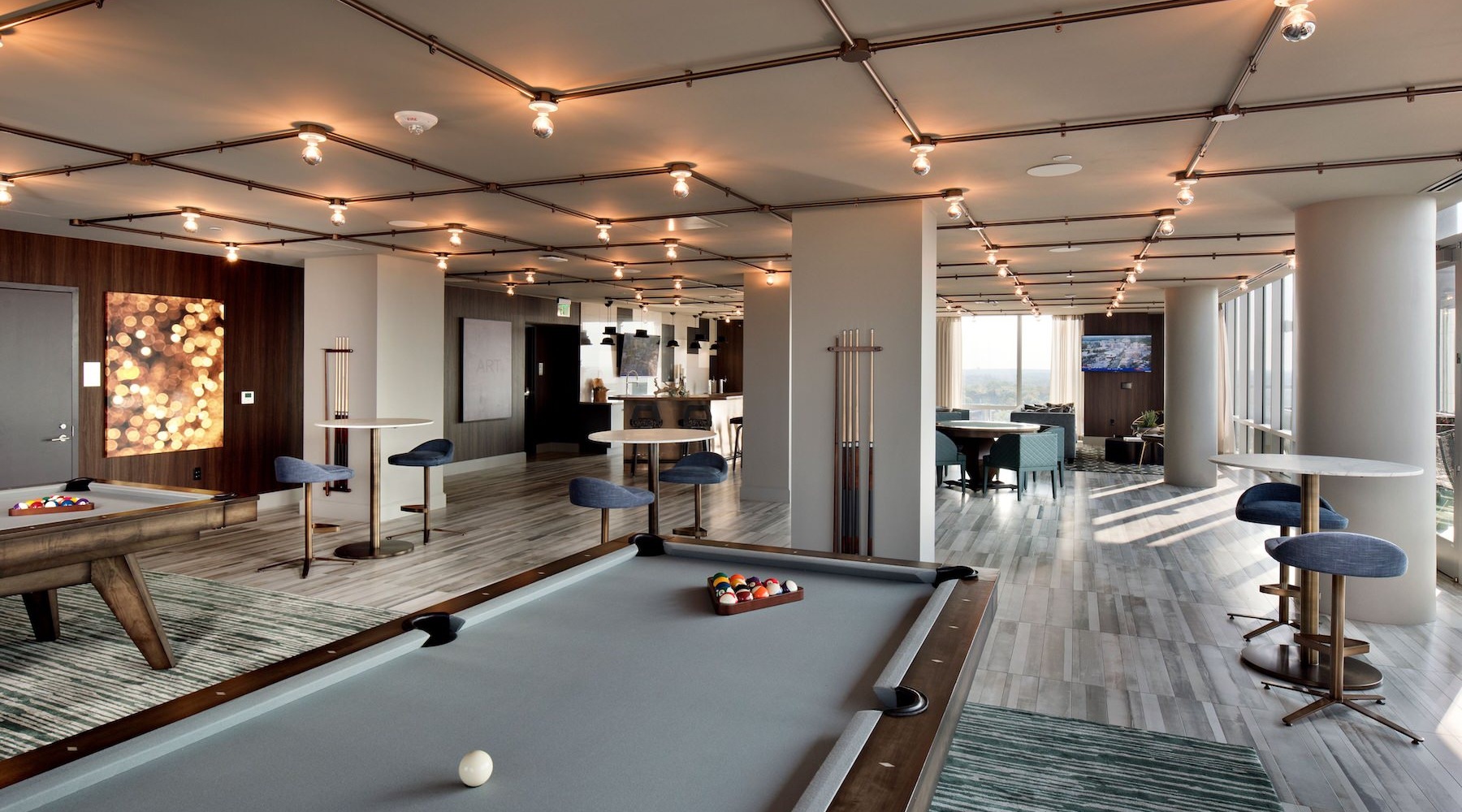 State-of-the-art amenities a pool table in a clubhouse room