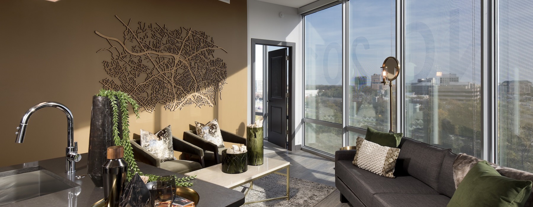 a living room with a large glass wall and a couch