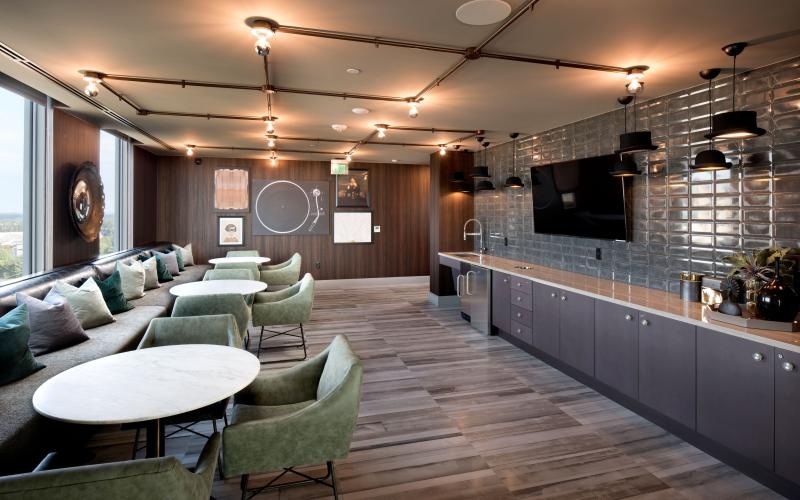 a clubhouse room with a couch and chairs