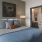 a bedroom with a bed and a chair