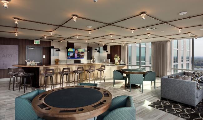 Access to resident-only features a clubhouse room with a bar and chairs
